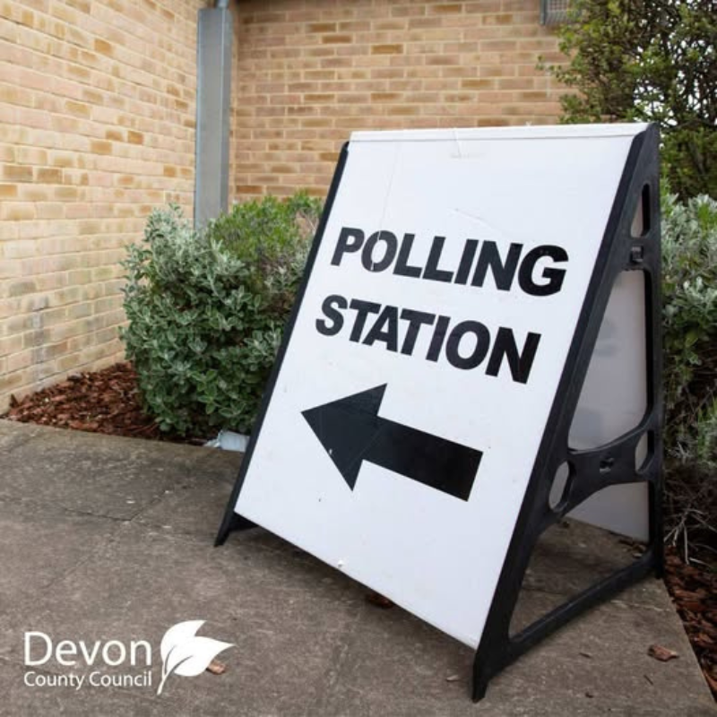 White A frame board with polling station and an arrow printed onto it.