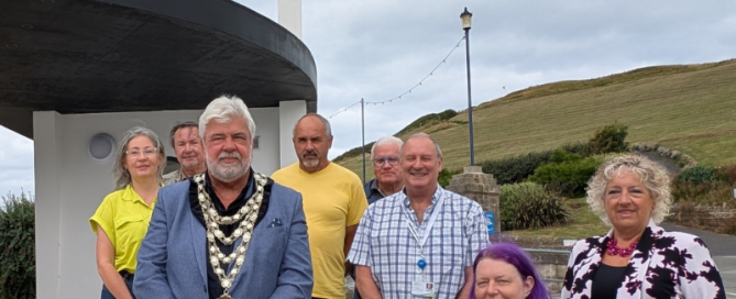 New Ilfracombe toilets and bus shelter shows picture of town and distrcit councillors standing in front of new toilet block